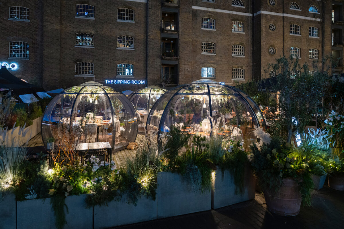 Outdoor alpine igloos at The Sipping Room at Drake & Morgan lit up