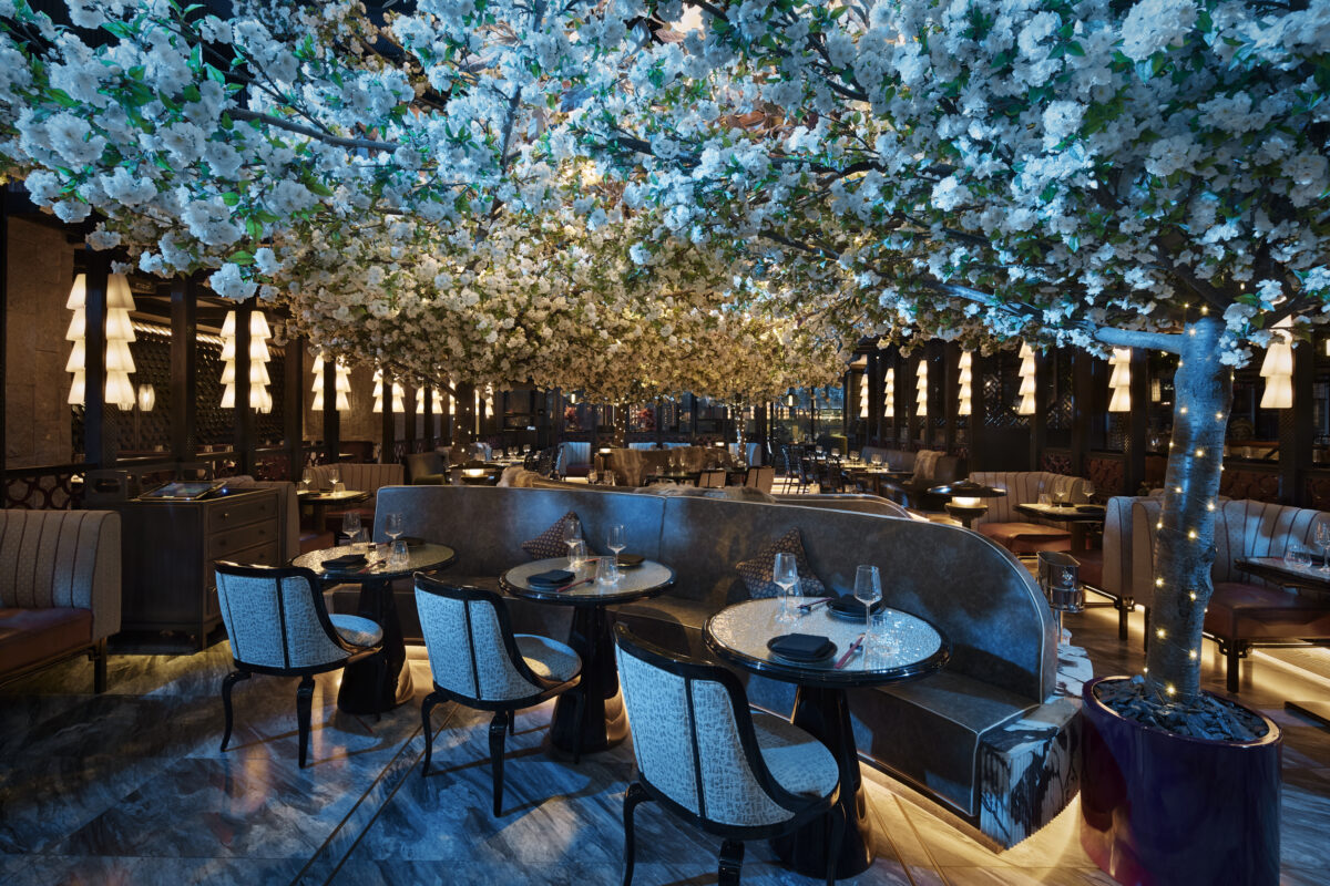 Stunning restaurant shot of Tattu London's dining room bathed in blue shimmering light