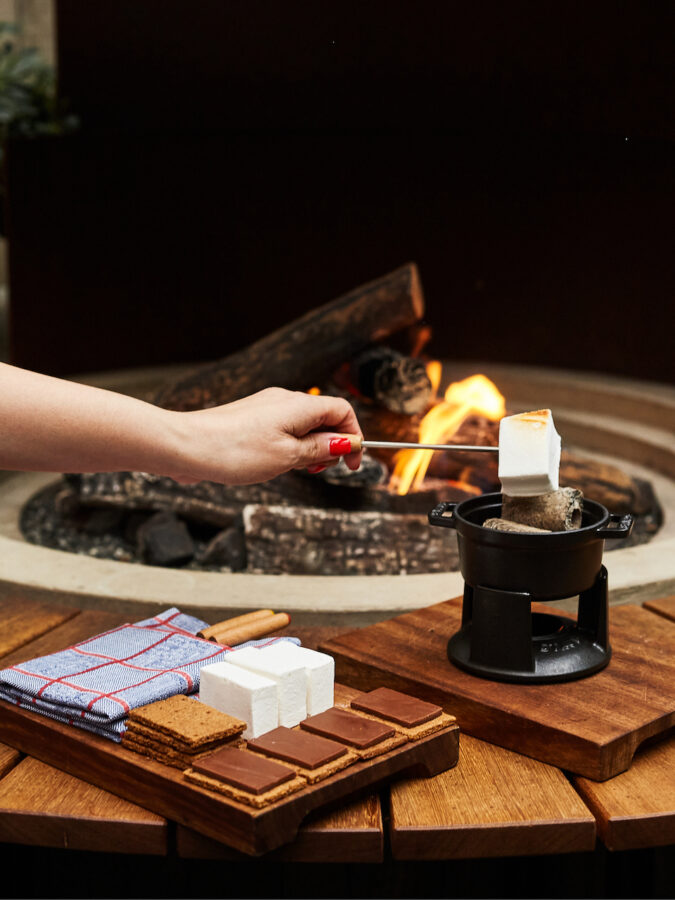 Toasting marshmallows by the fire with a tray of graham crackers and squares of chocolate at Isla Terrace at The Standard London