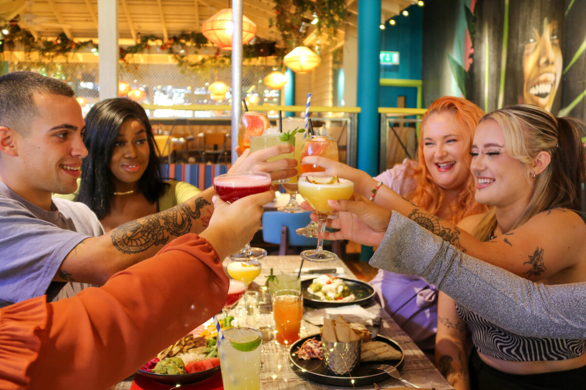 Friends saying cheers over their cocktails at Turtle Bay