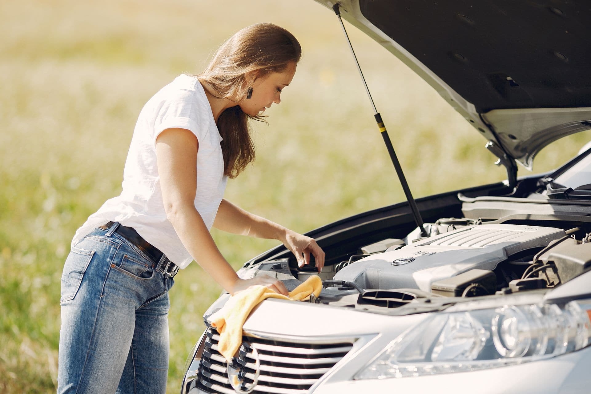 Woman performing inspection before her test drive of a potential used car