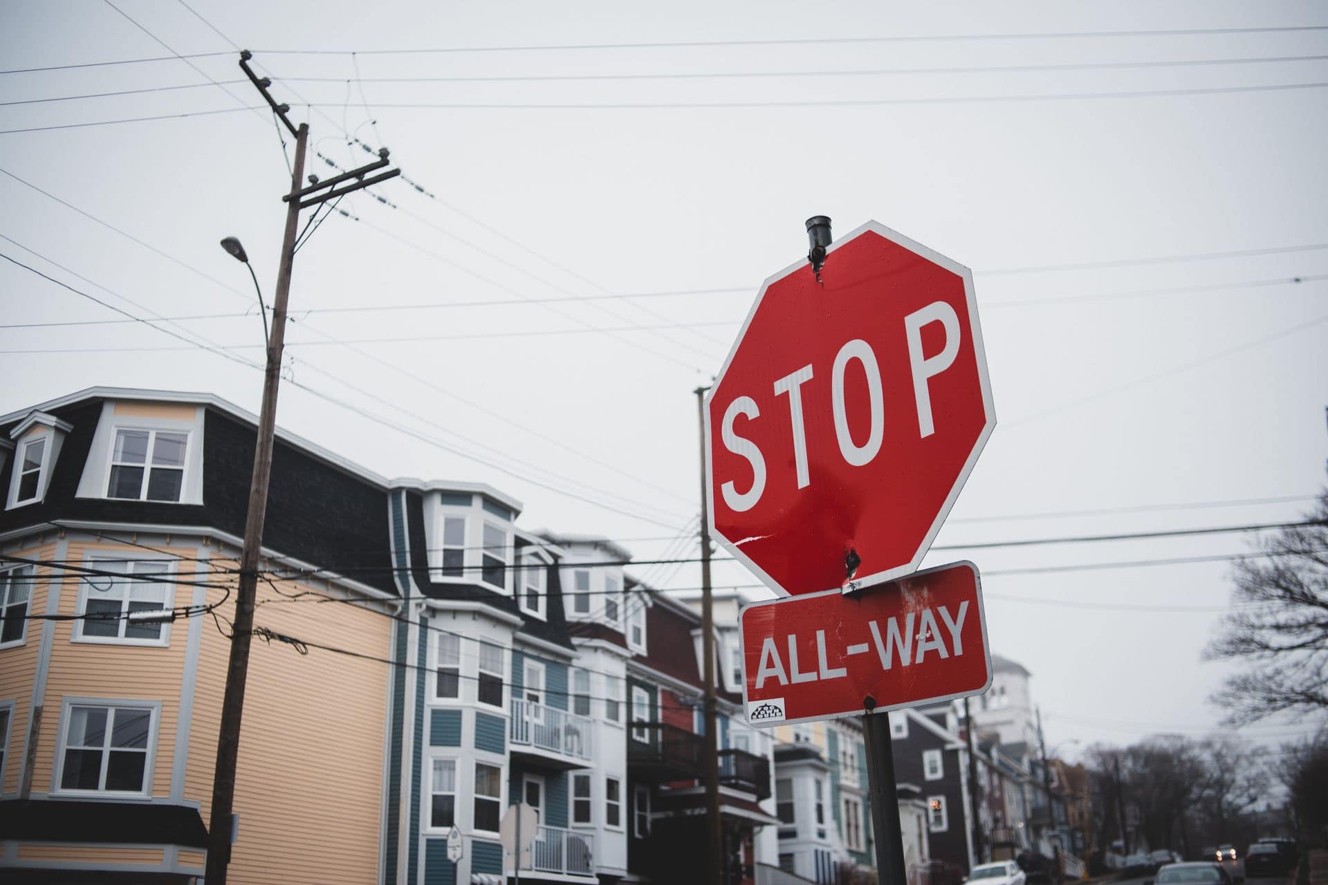 Stop sign hanging on broken down lamp post