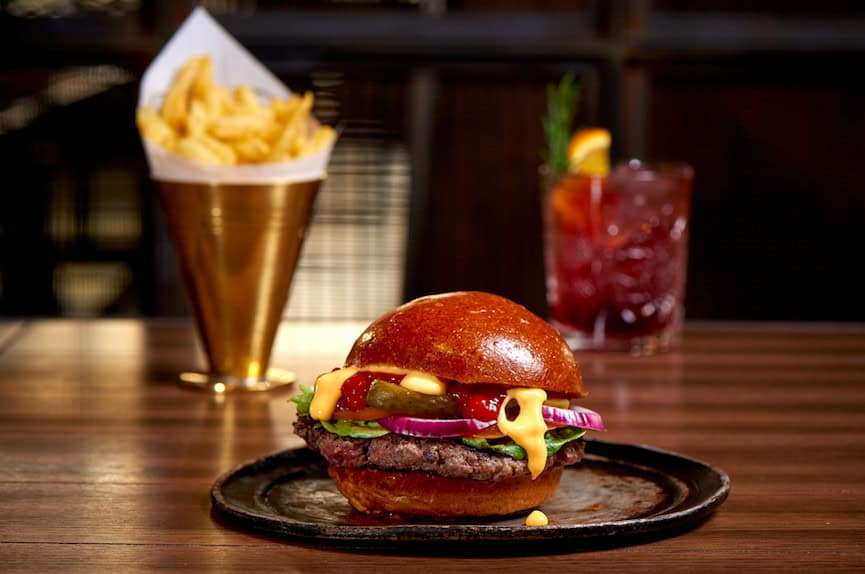 Modern Luxury in the Capital - Hilton London Bankside: The towering chunky Aberdeen Angus beef burgers stuffed with streaky bacon and Red Leicester Cheese at The Distillery