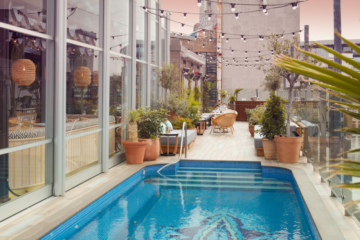 Laurel's on the Roof at Mondrian Shoreditch channels LA’s pool party scene with relaxed lounge seating, low-hanging rattan chandeliers and splashes of neon colours
