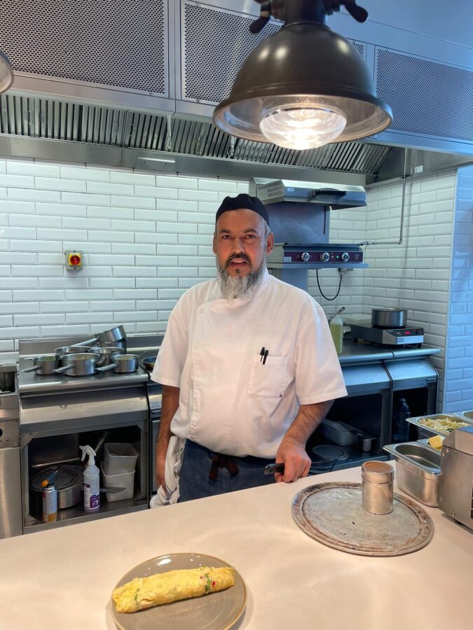 Chef Ali whipping up perfectly cooked omelettes in the kitchen at Oxbo! 