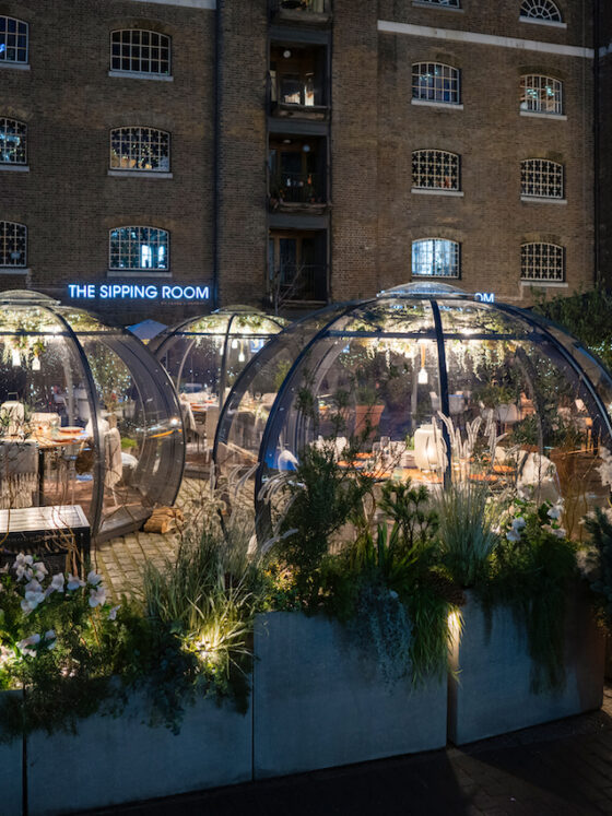 Outdoor alpine igloos at The Sipping Room at Drake & Morgan lit up