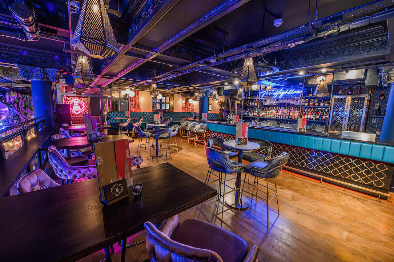 Mezzanine table area at Manahatta with upstairs bar