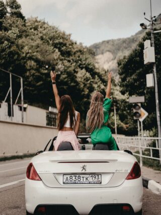 Girls on a road trip in a Peugeot