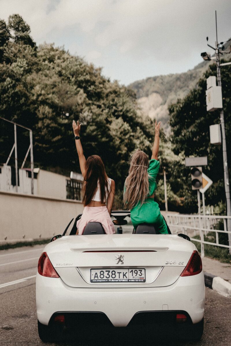 Girls on a road trip in a Peugeot