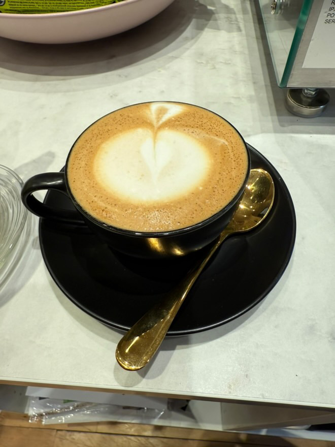 A cup of coffee with a picture of a heart in the milk art at Lily Brew Jesmond