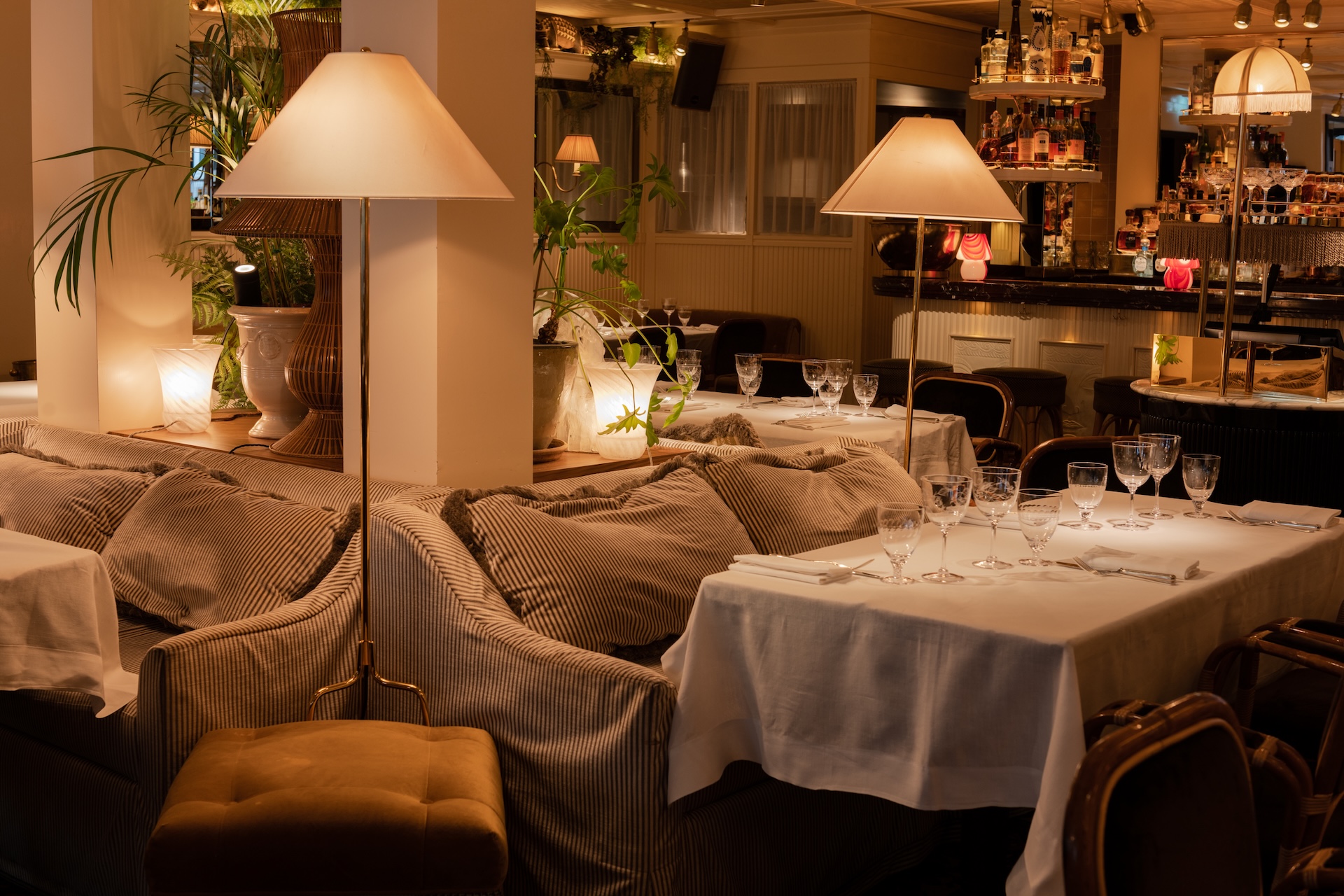 Interiors on the first floor of House of Louise with tables, chairs and standing lamps