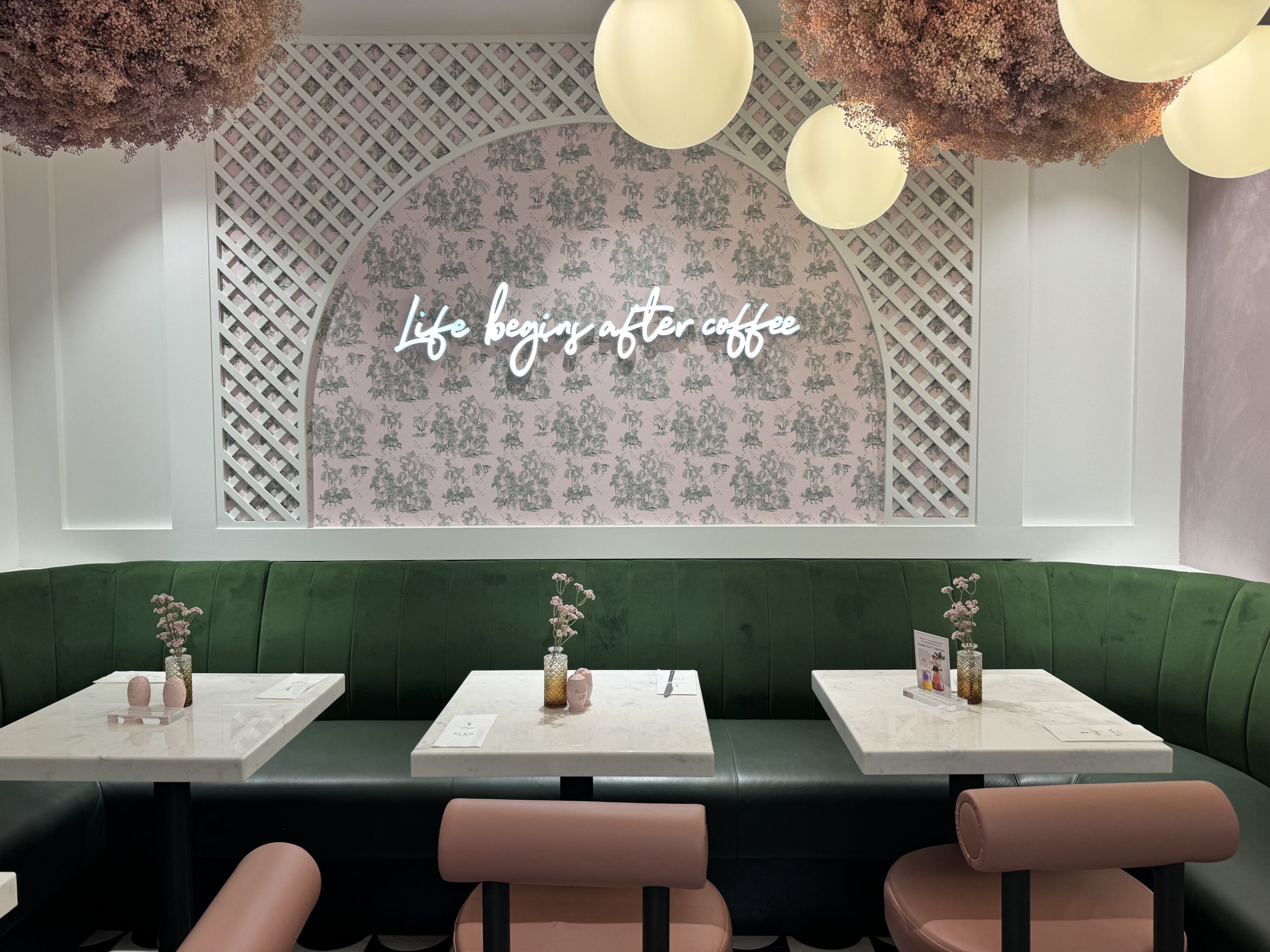Green banquette seating, pink chairs and a beautiful backdrop at EL&N cafe inside Fenwick Newcastle