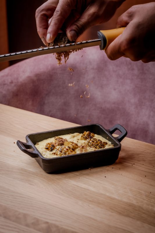 Fresh truffle being grated on a dish at Mr Porter