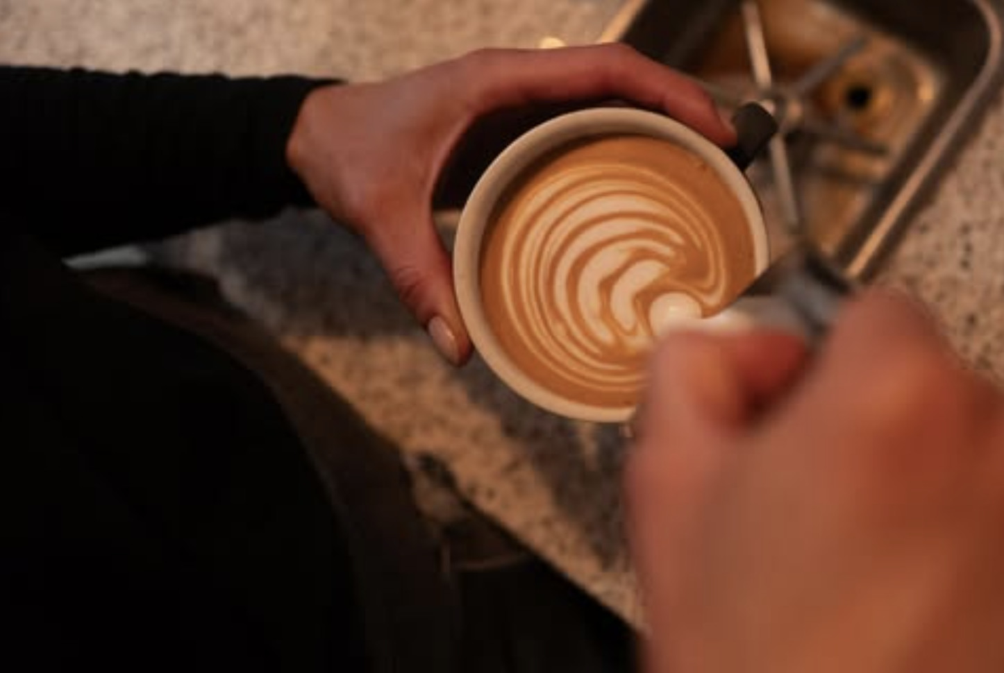 A coffee cup with milk art at Etto in Gosforth