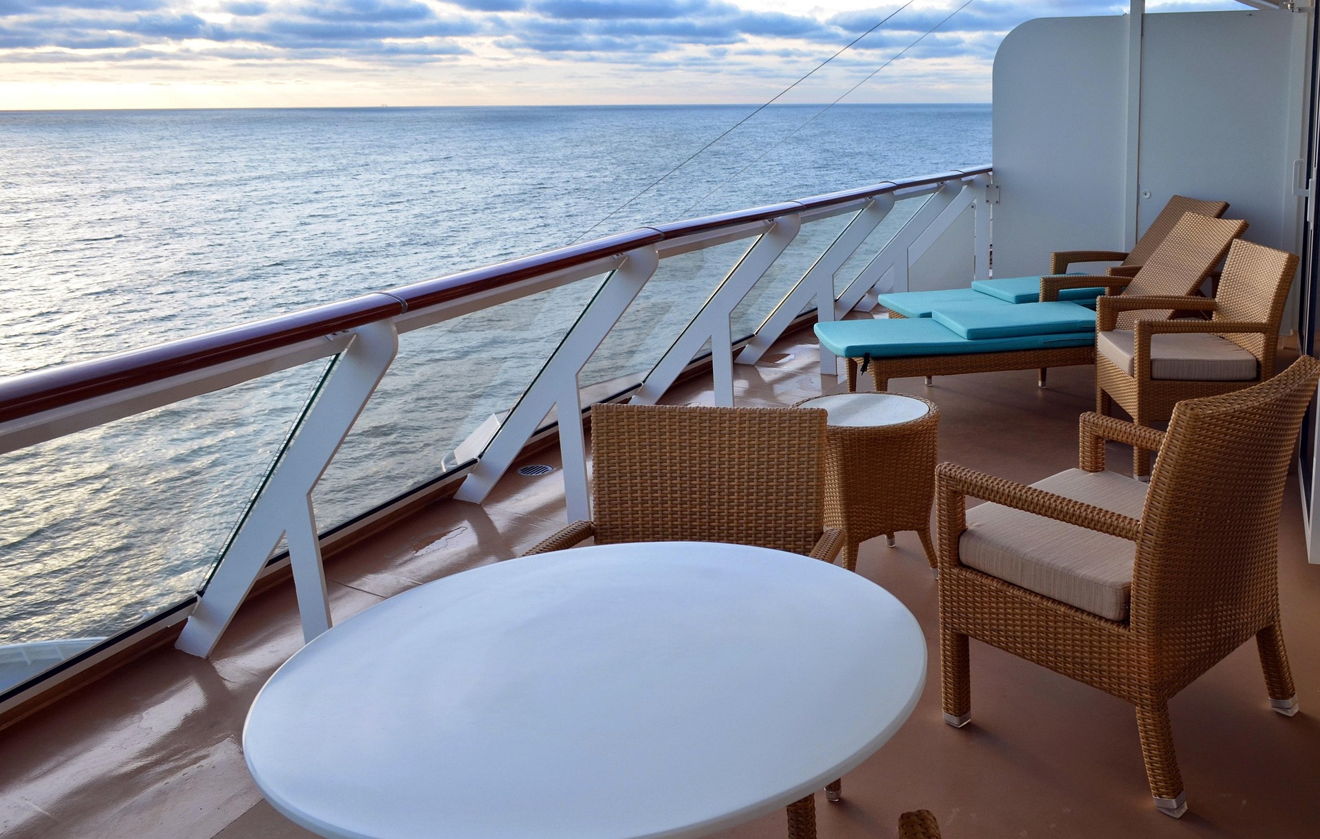 The Balcony on a luxury caribbean cruise with tables and chairs overlooking the ocean