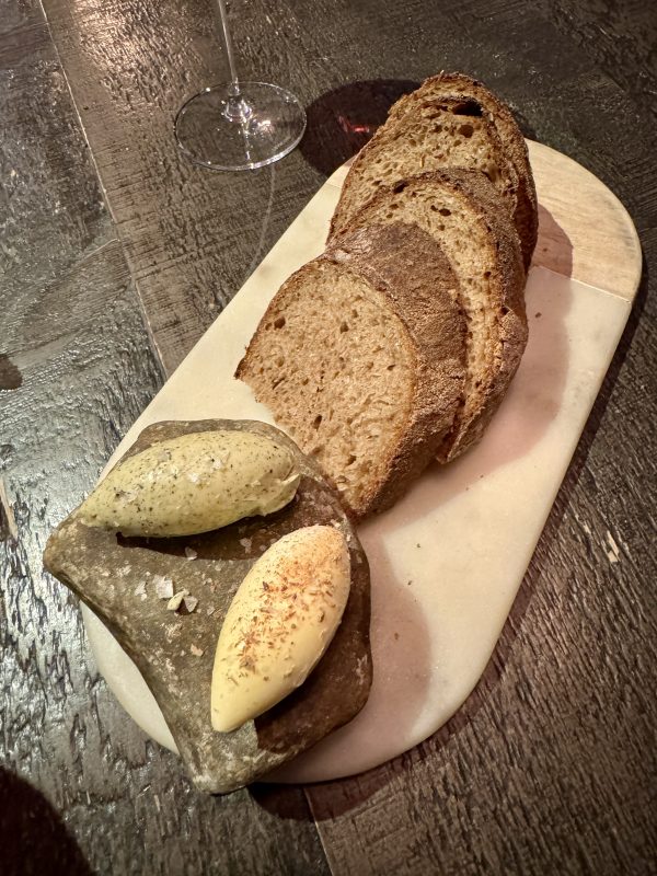 Tsuchi's tasting menu begins with fresh sourdough bread served with cultured whipped beef fat butter and nori seaweed butter