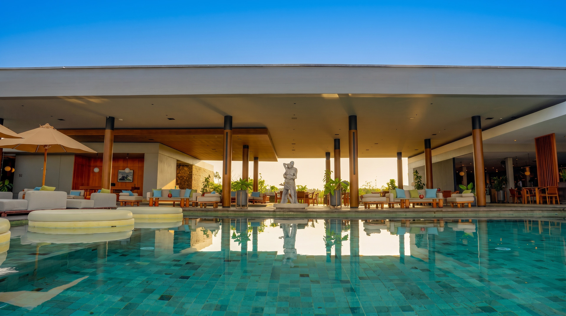 The BASK beach club with swimming pool, day beds in the water and a swim up bar